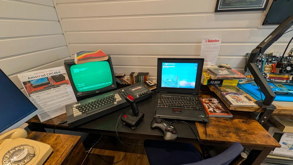 Two vintage home computers with keyboards, monitors and joysticks