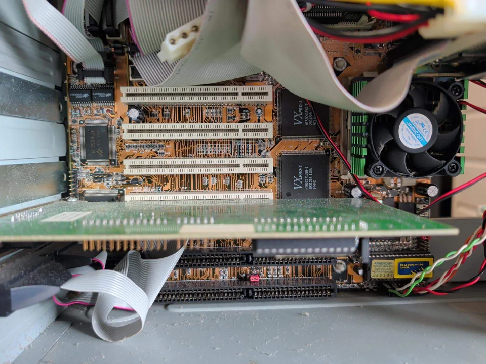 Circuit boards, ribbon cables and cooling fan inside a desktop computer