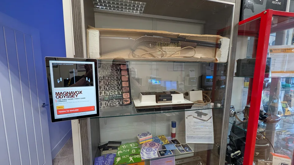 Magnavox Odyssey console and packaging in a glass display cabinet