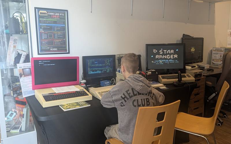 A young visitor exploring the BBC Micro and Commodore 64