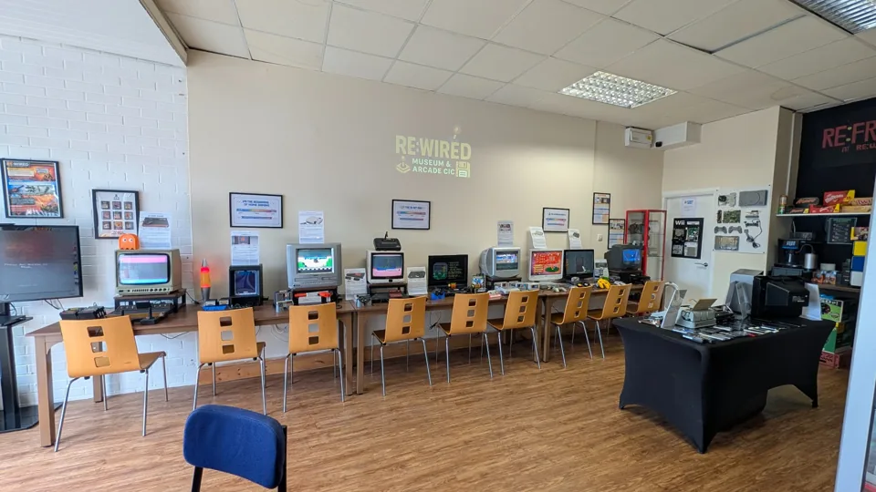 The museum room with a long row of playable computers and consoles